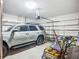 Spacious two-car garage with ample storage shelving, an automatic door opener, and room for vehicles and gear at 20749 Swallowtail Ct, Venice, FL 34293