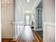 Hallway with a decorative table, detailed trim work, and hardwood flooring at 20749 Swallowtail Ct, Venice, FL 34293