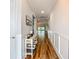 Long hallway with decorative table and natural light coming from the back of the house at 20749 Swallowtail Ct, Venice, FL 34293