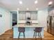 Open concept kitchen with a kitchen island, stainless appliances, and gray cabinets at 20749 Swallowtail Ct, Venice, FL 34293