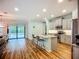 Open concept kitchen with a kitchen island, stainless appliances, and sliding doors to pool at 20749 Swallowtail Ct, Venice, FL 34293