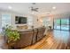Open-concept living room with a view of the pool, hardwood floors, and modern decor at 20749 Swallowtail Ct, Venice, FL 34293