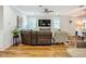 Spacious living room with hardwood floors, ceiling fan, and large sectional couch at 20749 Swallowtail Ct, Venice, FL 34293