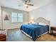 Well-lit bedroom boasts a ceiling fan, bright window, and tasteful decor for a peaceful retreat at 20749 Swallowtail Ct, Venice, FL 34293