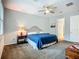 Inviting bedroom with cozy carpet, a ceiling fan, and comfortable furnishings for relaxation at 20749 Swallowtail Ct, Venice, FL 34293
