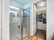 Large walk-in shower and walk-in closet featuring custom shelving to maximize storage space at 20749 Swallowtail Ct, Venice, FL 34293