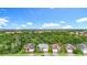 A high-angle street view of homes with well-maintained lawns and lush green surroundings at 20749 Swallowtail Ct, Venice, FL 34293
