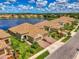 Stunning aerial view of homes by lake, showcasing tile roofs, lush landscaping and beautiful waterfront community at 21641 Winter Park Ct, Venice, FL 34293