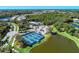 Aerial view of the community featuring tennis courts, a community center, and lush landscaping at 21641 Winter Park Ct, Venice, FL 34293