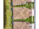 Stunning aerial view of rooftops showcases meticulously maintained landscaping and beautiful tile work in a well-planned community at 21641 Winter Park Ct, Venice, FL 34293