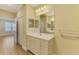 Bathroom vanity with ample storage, large mirror, and view to bedroom at 21641 Winter Park Ct, Venice, FL 34293