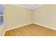 Bright, empty room with wood floors, fresh paint and a window with white blinds at 21641 Winter Park Ct, Venice, FL 34293