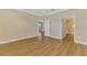 Empty bedroom with hardwood floors, neutral walls, and a view into the bathroom at 21641 Winter Park Ct, Venice, FL 34293