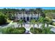 Scenic front exterior featuring mature landscaping and palm trees at 21641 Winter Park Ct, Venice, FL 34293