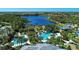 Aerial view of the community pool area showcasing a large pool, waterslide, hot tub, and lush landscaping at 21641 Winter Park Ct, Venice, FL 34293