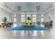 Spacious community room with seating areas, large windows, and decorative light fixtures at 21641 Winter Park Ct, Venice, FL 34293
