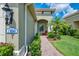 Inviting front entrance featuring a brick walkway, address plaque, and lush landscaping at 21641 Winter Park Ct, Venice, FL 34293