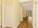 Bright hallway with wood floors leading to an open living space and bedrooms at 21641 Winter Park Ct, Venice, FL 34293