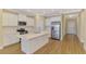 Bright, open kitchen with an island, stainless steel appliances, and wood floors at 21641 Winter Park Ct, Venice, FL 34293