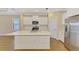 Modern kitchen showcasing stainless steel appliances, white cabinetry, and an island with a quartz countertop at 21641 Winter Park Ct, Venice, FL 34293