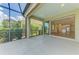 Relaxing lanai offering a view of the lush landscaping and a glimpse of the home's interior at 21641 Winter Park Ct, Venice, FL 34293