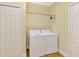 Convenient laundry room featuring a washer, dryer, storage closet, and overhead shelving at 21641 Winter Park Ct, Venice, FL 34293