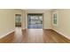 Bright living room with wood floors and large glass doors leading to an outdoor patio with a lake view at 21641 Winter Park Ct, Venice, FL 34293