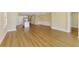 Wide shot of a living room with a dining area, kitchen, wood floors, and recessed lighting at 21641 Winter Park Ct, Venice, FL 34293