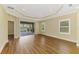 Spacious living room with wood floors, recessed lighting, and a sliding door with view of the backyard and lake at 21641 Winter Park Ct, Venice, FL 34293