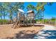 Well-maintained wooden playground with multiple levels, providing a fun and safe play area for children at 21641 Winter Park Ct, Venice, FL 34293
