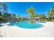 Community pool with palm trees and cabanas, perfect for relaxation and recreation at 21641 Winter Park Ct, Venice, FL 34293