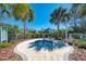 Outdoor community spa area featuring a hot tub, seating, and landscaping at 21641 Winter Park Ct, Venice, FL 34293