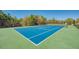 Tennis court featuring blue playing surface with green exterior at 21641 Winter Park Ct, Venice, FL 34293
