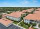 Aerial view of condos with tile roofs, mature landscaping, and parking at 2204 L Pavia Blvd # 2204, Venice, FL 34292