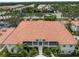 Aerial view of complex, showcasing the well-maintained tile roofs, mature landscaping, and stairways at 2204 L Pavia Blvd # 2204, Venice, FL 34292
