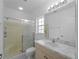 Bathroom with shower, large mirror, and vanity with marble countertop at 2204 L Pavia Blvd # 2204, Venice, FL 34292