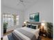 Bright bedroom with a window, a bed, and two plants at 2204 L Pavia Blvd # 2204, Venice, FL 34292