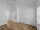 Open bedroom view with white walls, wood flooring, and ensuite bathroom at 2204 L Pavia Blvd # 2204, Venice, FL 34292