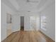 Bright bedroom with ensuite bathroom, walk-in closet, wood-look flooring, and ceiling fan at 2204 L Pavia Blvd # 2204, Venice, FL 34292
