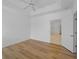 Bright bedroom with wood-look flooring, white walls, and a ceiling fan at 2204 L Pavia Blvd # 2204, Venice, FL 34292