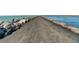 Long breakwater walkway stretching out to the ocean, lined with large rocks and ocean on both sides at 2204 L Pavia Blvd # 2204, Venice, FL 34292