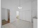 Open dining room with tile floors, elegant lighting, and access to a bathroom at 2204 L Pavia Blvd # 2204, Venice, FL 34292