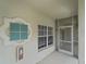 Screened-in patio entrance with a window and a fire extinguisher on the wall at 2204 L Pavia Blvd # 2204, Venice, FL 34292