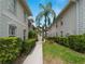 Well-maintained condo building with lush landscaping and walkway at 2204 L Pavia Blvd # 2204, Venice, FL 34292