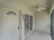 Inviting front door with decorative window and sliding door to the screened porch at 2204 L Pavia Blvd # 2204, Venice, FL 34292