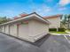 Detached garage with neutral stucco and a red tile roof next to a paved driveway at 2204 L Pavia Blvd # 2204, Venice, FL 34292