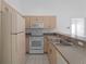 Classic kitchen design with white appliances and neutral countertops in a well-lit space at 2204 L Pavia Blvd # 2204, Venice, FL 34292