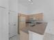 A kitchen with neutral countertops, white cabinets, and appliances, including a breakfast bar at 2204 L Pavia Blvd # 2204, Venice, FL 34292