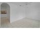 Spacious living room featuring tile floors, arched doorway and view of the kitchen at 2204 L Pavia Blvd # 2204, Venice, FL 34292