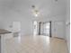 Spacious living room with tile floors, ceiling fan, and sliding glass doors at 2204 L Pavia Blvd # 2204, Venice, FL 34292
